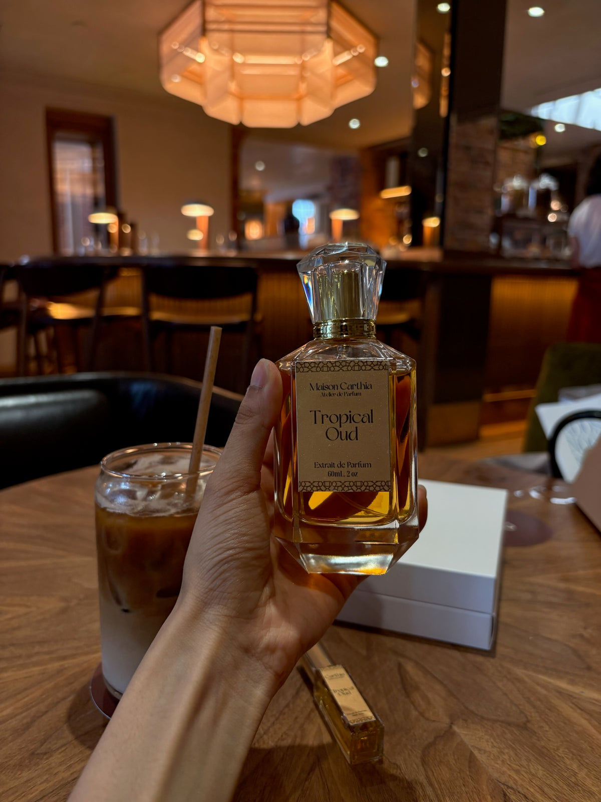 A Maison Carthia bottle in a warm lounge