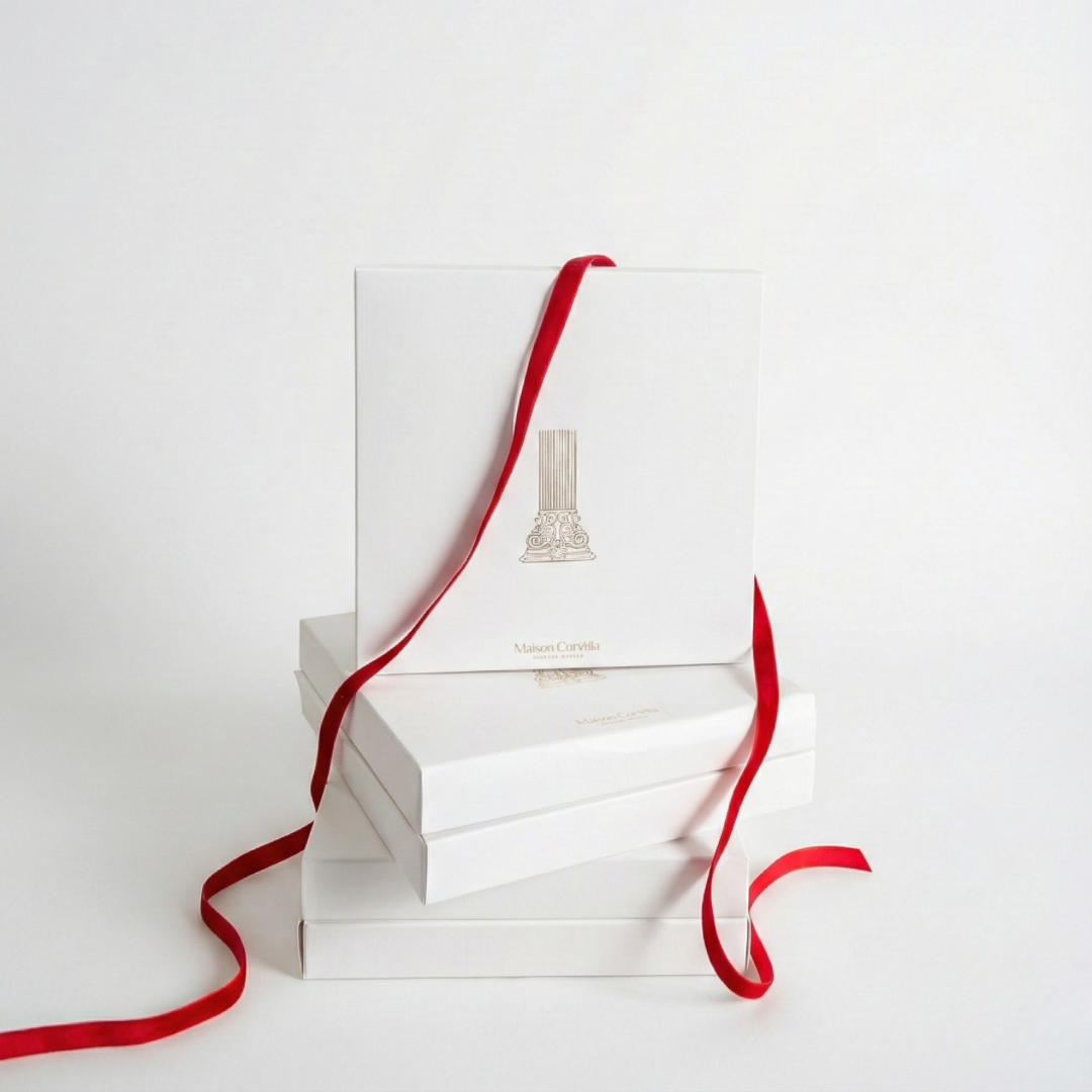 White Maison Carthia gift boxes tied with ribbon