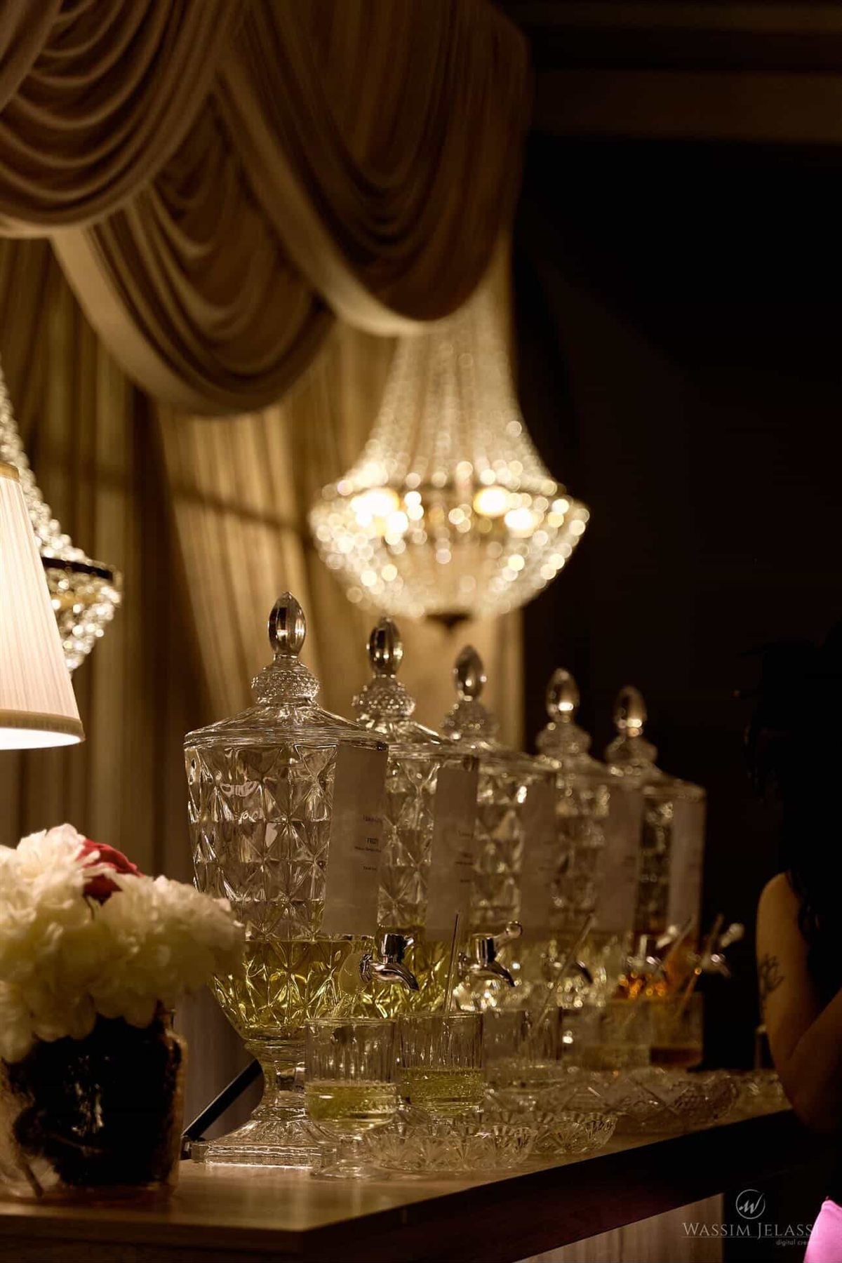 The bar in service, beneath the chandeliers.
